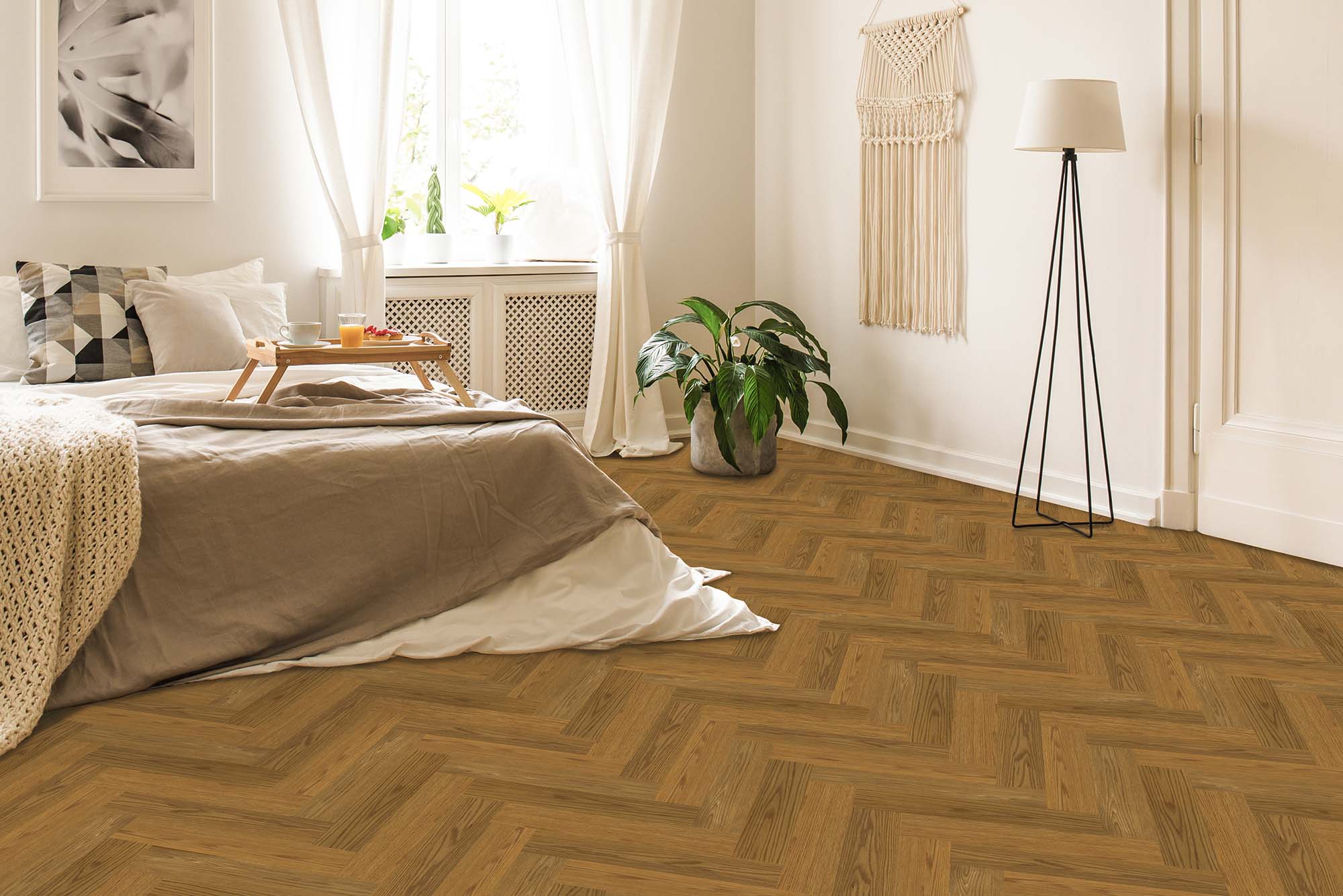 Bedroom featuring the Lumin Essence bed positioned beside a window adorned with white curtains, accompanied by a potted plant, a standing lamp, and a stylish wall hanging. The wooden floor is laid out in an elegant herringbone pattern.