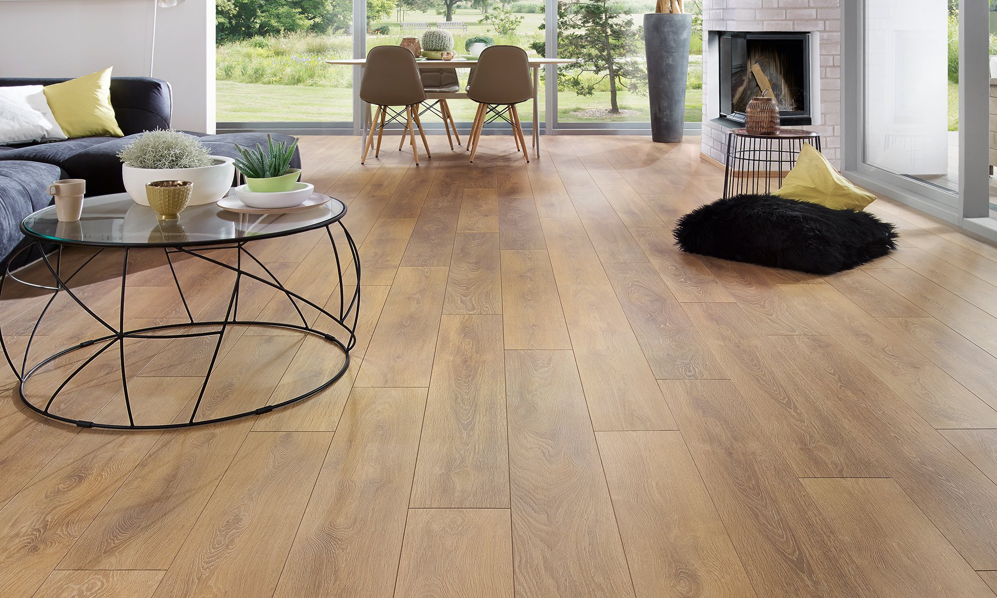 Image of a cozy living room with warm, medium-toned flooring. The rich wood tones create a welcoming ambiance and complement the room’s neutral-coloured walls and plush furnishings