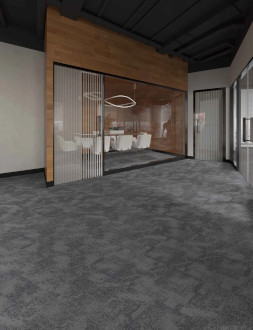 Contemporary office space featuring Carpet-Tile-m in gray, a glass-walled conference room with white chairs, and a circular ceiling light fixture.